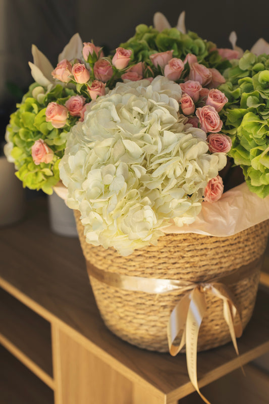 L size basket with hydrangeas, spray roses and orchids